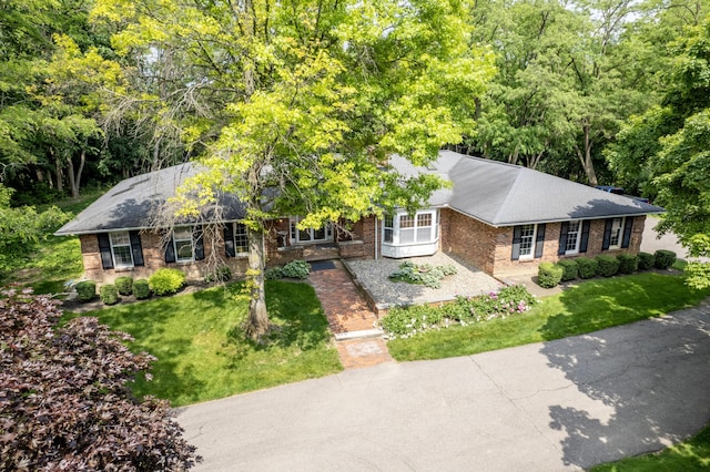 144 Barton N Dr, Ann Arbor, MI 48105 - ranch-style home featuring brick siding, a front lawn, and a shingled roof