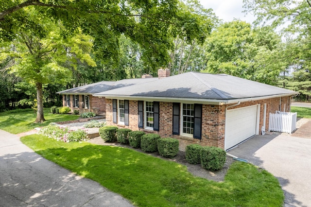144 Barton N Dr, Ann Arbor, MI 48105 - ranch-style house with driveway, brick siding, an attached garage, roof with shingles, and a chimney