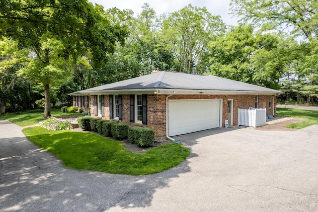 144 Barton N Dr, Ann Arbor, MI 48105 - view of front of property with asphalt driveway, brick siding, an attached garage, a front lawn, and a chimney