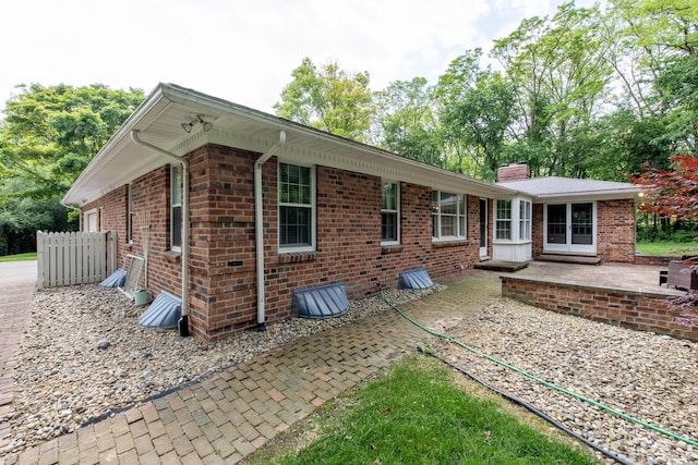 144 Barton N Dr, Ann Arbor, MI 48105 - rear view of property featuring a patio, a chimney, and brick siding