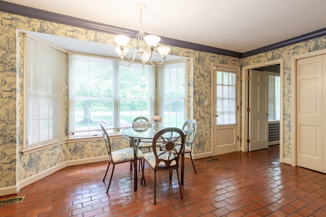 144 Barton N Dr, Ann Arbor, MI 48105 - dining space with brick floors, a chandelier, wallpapered walls, and crown molding