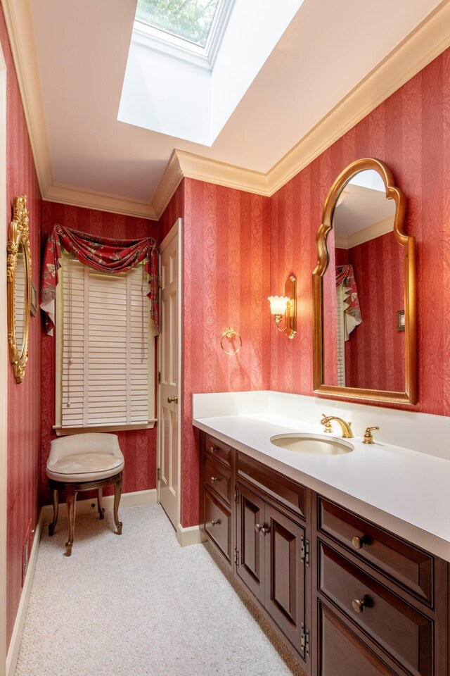 144 Barton N Dr, Ann Arbor, MI 48105 - bathroom with a skylight, vanity, ornamental molding, and wallpapered walls
