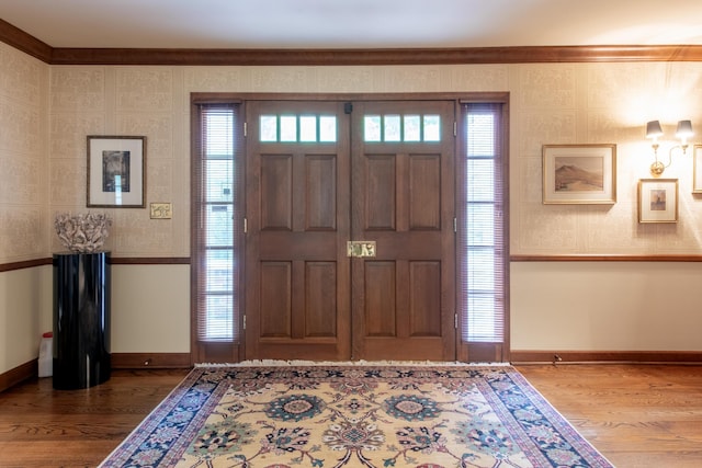144 Barton N Dr, Ann Arbor, MI 48105 - foyer entrance featuring wood finished floors, ornamental molding, and healthy amount of natural light