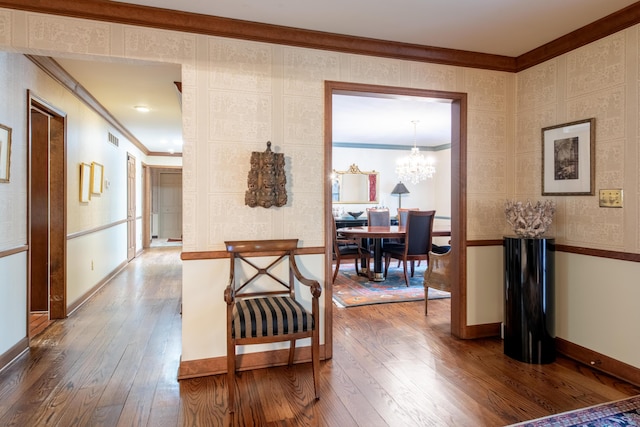 144 Barton N Dr, Ann Arbor, MI 48105 - hall featuring crown molding, wood-type flooring, and a chandelier