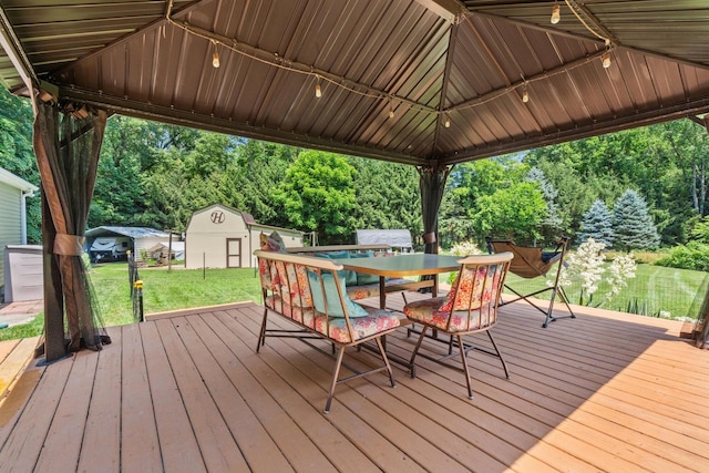 69291 Brush Trl, Niles, MI 49120 - deck featuring a storage shed, a lawn, outdoor dining area, and view of wooded area