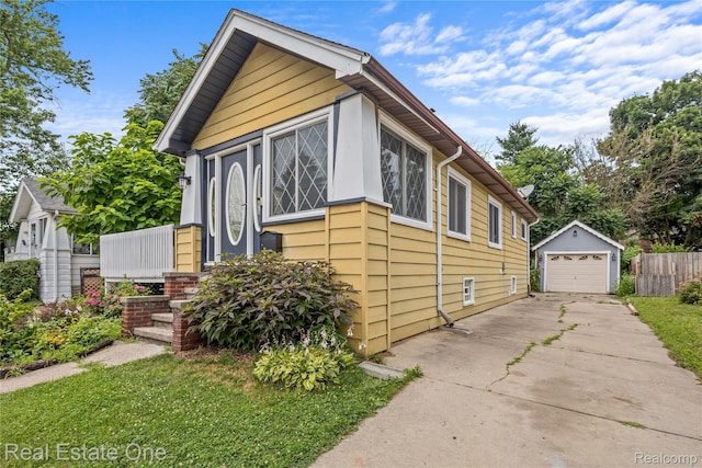 212 La Plaza Ct, Royal Oak, MI 48073 - view of front facade with driveway, a garage, and an outdoor structure