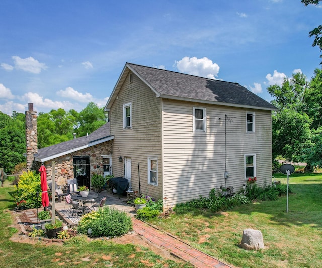 278 E Southern Rd, Coldwater, MI 49036 - back of property with a patio, a lawn, and a shingled roof