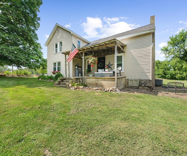 278 E Southern Rd, Coldwater, MI 49036 - rear view of house with a chimney, a lawn, and a patio