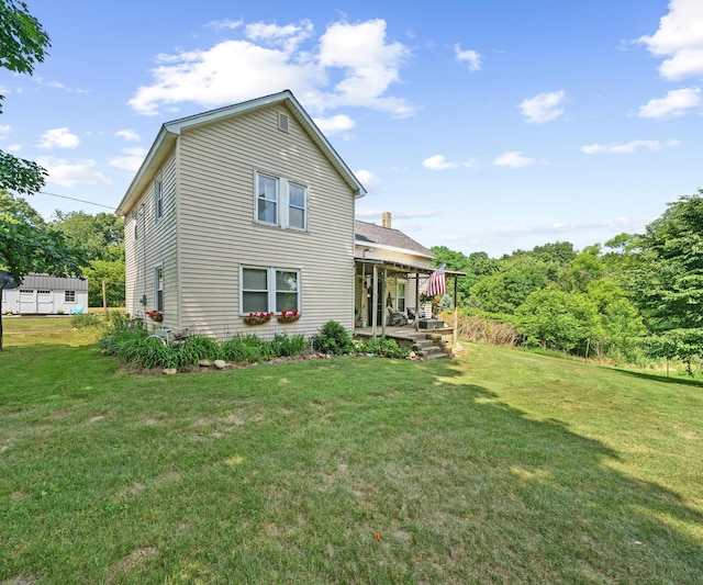 278 E Southern Rd, Coldwater, MI 49036 - back of property with a lawn, covered porch, and a chimney