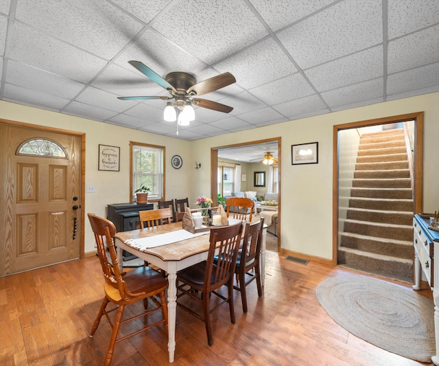 278 E Southern Rd, Coldwater, MI 49036 - dining area with a drop ceiling, light wood-type flooring, ceiling fan, and stairs