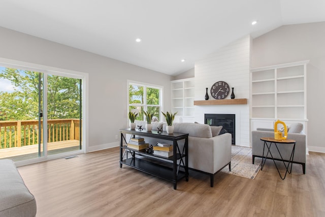 1519 Eagle Shore Ct, Hudsonville, MI 49426 - living area with vaulted ceiling, light wood-type flooring, built in shelves, a large fireplace, and recessed lighting