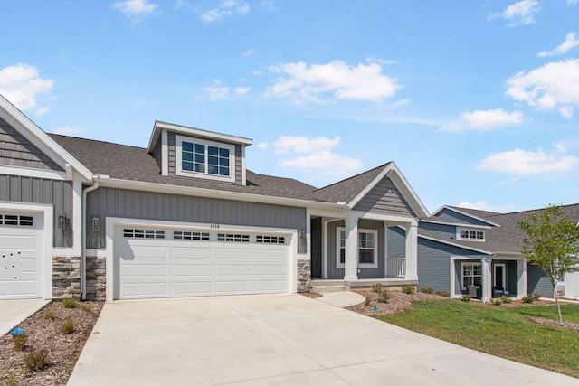 1519 Eagle Shore Ct, Hudsonville, MI 49426 - craftsman inspired home with board and batten siding, concrete driveway, an attached garage, stone siding, and a shingled roof