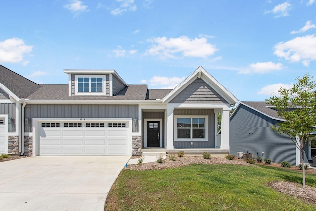 1519 Eagle Shore Ct, Hudsonville, MI 49426 - craftsman-style home featuring board and batten siding, concrete driveway, a front yard, an attached garage, and roof with shingles