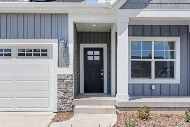1519 Eagle Shore Ct, Hudsonville, MI 49426 - doorway to property featuring board and batten siding and stone siding