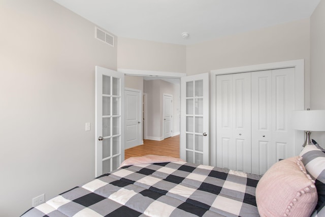 1519 Eagle Shore Ct, Hudsonville, MI 49426 - bedroom featuring french doors, a closet, and wood finished floors