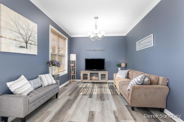 5845 Nile Dr SW, Wyoming, MI 49418 - living room featuring a chandelier, wood finished floors, and crown molding