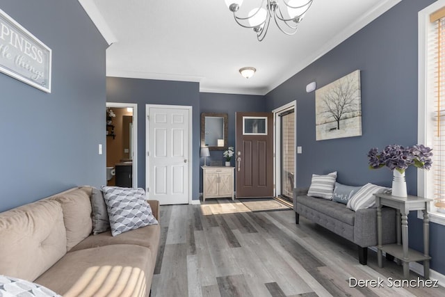 5845 Nile Dr SW, Wyoming, MI 49418 - living room featuring a chandelier, wood finished floors, and crown molding