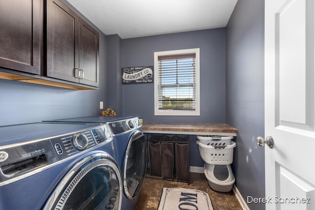 5845 Nile Dr SW, Wyoming, MI 49418 - laundry room featuring cabinet space, independent washer and dryer, and dark stone finish floors