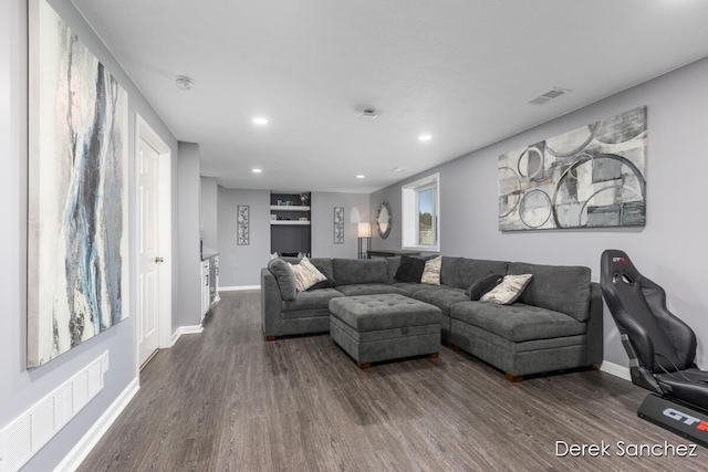 5845 Nile Dr SW, Wyoming, MI 49418 - living area featuring dark wood-style flooring and recessed lighting
