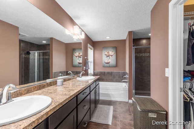 5845 Nile Dr SW, Wyoming, MI 49418 - bathroom featuring tile patterned flooring, a stall shower, a spacious closet, a bath, and double vanity