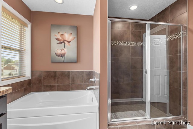 5845 Nile Dr SW, Wyoming, MI 49418 - bathroom with a bath, a shower stall, recessed lighting, and a textured ceiling