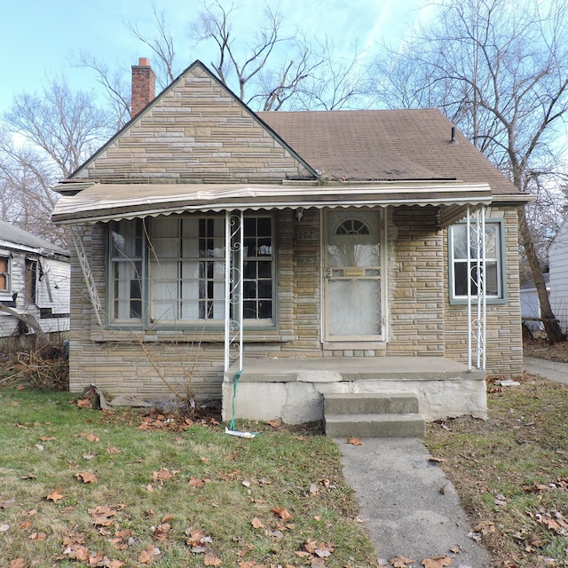 20026 Avon Ave, Detroit, MI 48219 - view of front of house with a chimney and stone siding