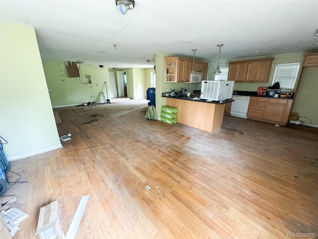 7889 Chilson Rd, Hamburg, MI 48169 - kitchen featuring dark countertops, white appliances, light wood-style floors, open floor plan, and a peninsula