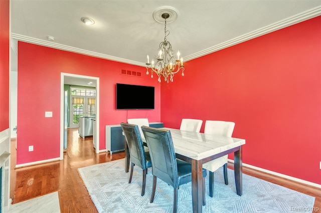 584 Cambridge Way, Bloomfield Hills, MI 48304 - dining space with a chandelier, crown molding, and wood finished floors