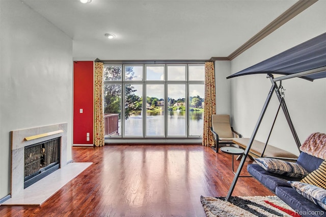 584 Cambridge Way, Bloomfield Hills, MI 48304 - living room featuring wood finished floors, crown molding, a high end fireplace, and a water view