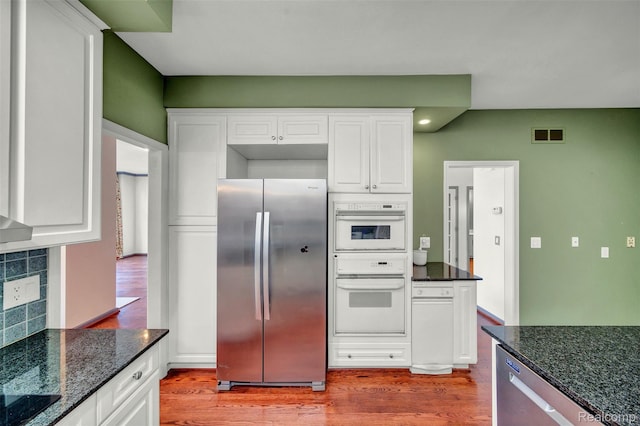 584 Cambridge Way, Bloomfield Hills, MI 48304 - kitchen with stainless steel appliances, light wood finished floors, white cabinetry, dark stone countertops, and recessed lighting