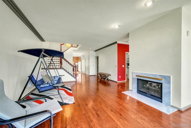 584 Cambridge Way, Bloomfield Hills, MI 48304 - unfurnished living room featuring stairs, wood finished floors, a high end fireplace, and ornamental molding