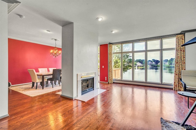 584 Cambridge Way, Bloomfield Hills, MI 48304 - living area with a chandelier, wood finished floors, crown molding, a water view, and expansive windows