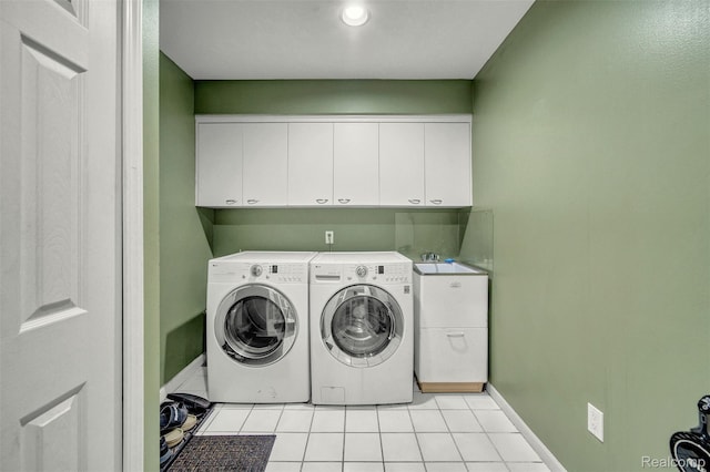 584 Cambridge Way, Bloomfield Hills, MI 48304 - washroom with washing machine and clothes dryer, light tile patterned flooring, and cabinet space