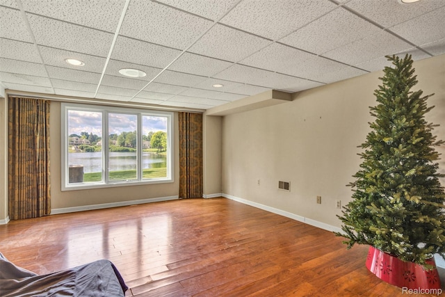 584 Cambridge Way, Bloomfield Hills, MI 48304 - unfurnished living room featuring wood finished floors, a paneled ceiling, and a water view