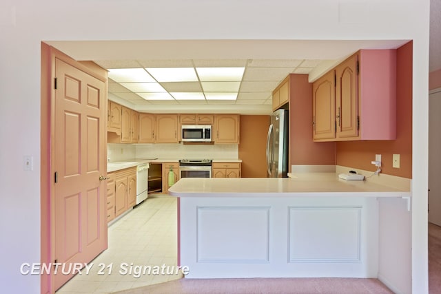 4515 Gratiot Rd, Saginaw, MI 48638 - kitchen with stainless steel appliances, a paneled ceiling, a peninsula, and light countertops