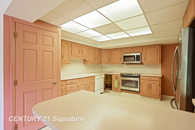 4515 Gratiot Rd, Saginaw, MI 48638 - kitchen featuring stainless steel appliances, a paneled ceiling, decorative backsplash, and light countertops