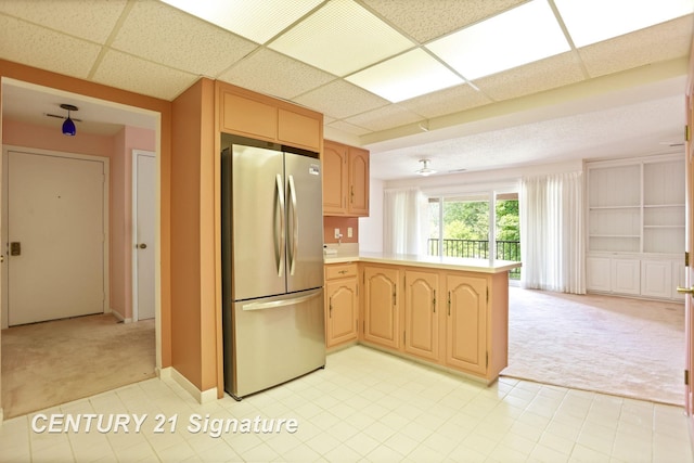 4515 Gratiot Rd, Saginaw, MI 48638 - kitchen featuring freestanding refrigerator, light colored carpet, a peninsula, light countertops, and open floor plan