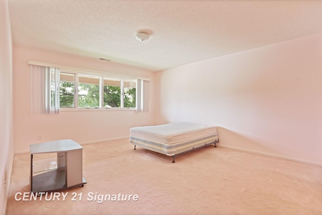 4515 Gratiot Rd, Saginaw, MI 48638 - carpeted bedroom featuring baseboards and a textured ceiling