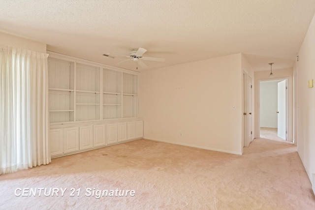 4515 Gratiot Rd, Saginaw, MI 48638 - empty room featuring light colored carpet, ceiling fan, and a textured ceiling