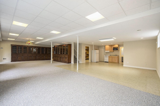 436 Pine Brae St, Ann Arbor, MI 48105 - unfurnished living room featuring stairs, a drop ceiling, and light floors