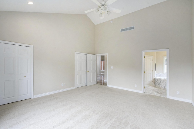 436 Pine Brae St, Ann Arbor, MI 48105 - unfurnished bedroom featuring high vaulted ceiling, multiple closets, light carpet, ensuite bathroom, and a ceiling fan
