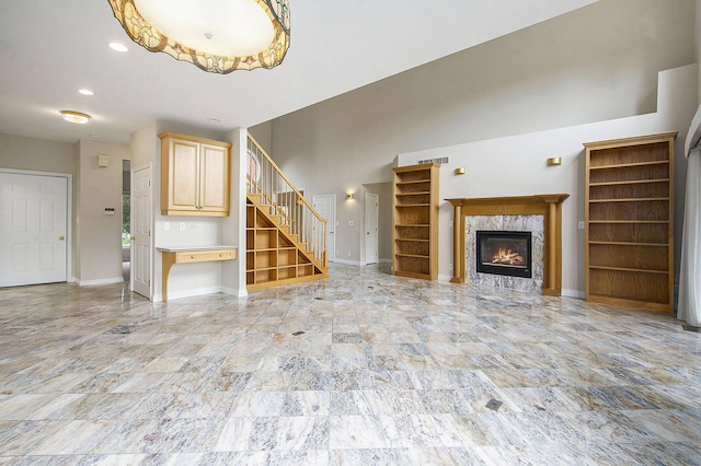 436 Pine Brae St, Ann Arbor, MI 48105 - unfurnished living room with stairs and a high end fireplace