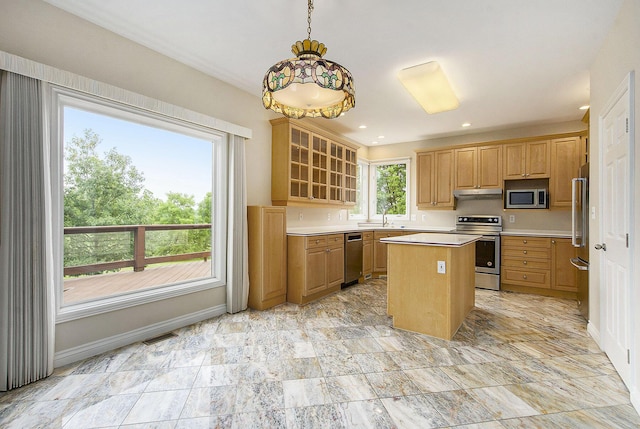 436 Pine Brae St, Ann Arbor, MI 48105 - kitchen featuring appliances with stainless steel finishes, a center island, light countertops, glass insert cabinets, and pendant lighting