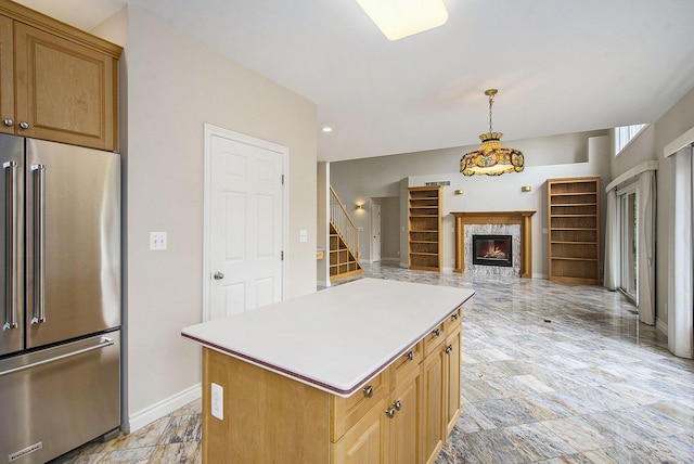 436 Pine Brae St, Ann Arbor, MI 48105 - kitchen with high end refrigerator, light countertops, a center island, a premium fireplace, and decorative light fixtures