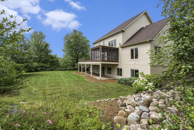 436 Pine Brae St, Ann Arbor, MI 48105 - rear view of house featuring a sunroom, a patio, a yard, and a shingled roof