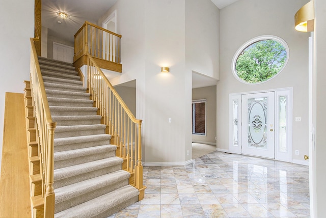 436 Pine Brae St, Ann Arbor, MI 48105 - foyer with marble tiled flooring, a high ceiling, and stairway