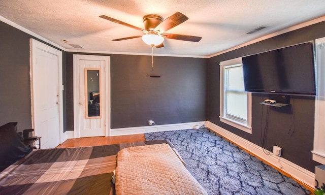 500 W Chicago St, Coldwater, MI 49036 - bedroom featuring a textured ceiling, crown molding, a ceiling fan, and wood finished floors