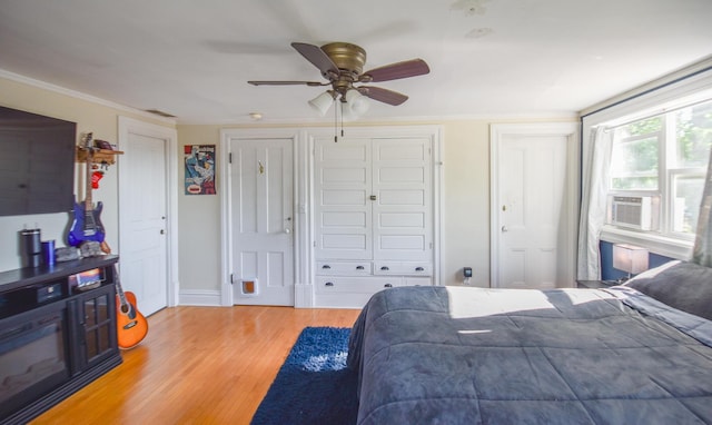 500 W Chicago St, Coldwater, MI 49036 - bedroom featuring multiple closets, light wood finished floors, a ceiling fan, crown molding, and cooling unit