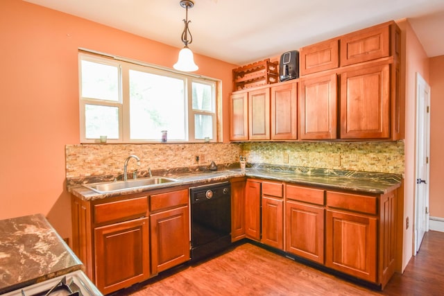 500 W Chicago St, Coldwater, MI 49036 - kitchen with dishwasher, light wood-type flooring, decorative backsplash, brown cabinetry, and hanging light fixtures