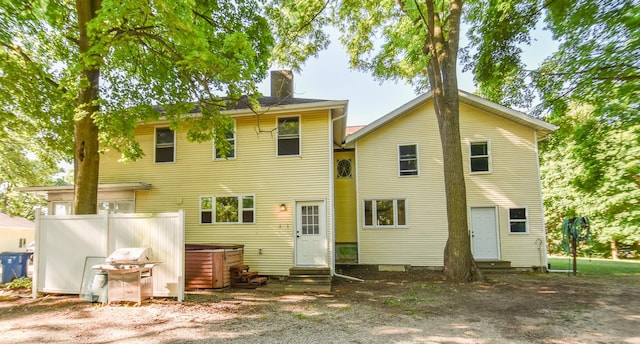 500 W Chicago St, Coldwater, MI 49036 - rear view of house featuring entry steps, a chimney, and a hot tub